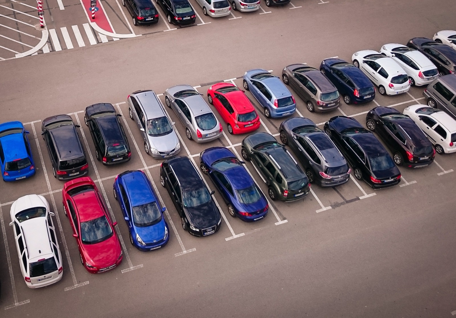Aerial view of a lot full of parked cars.